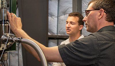 Two people examining a device.