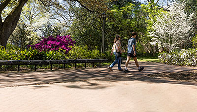 Two people walking on campus.